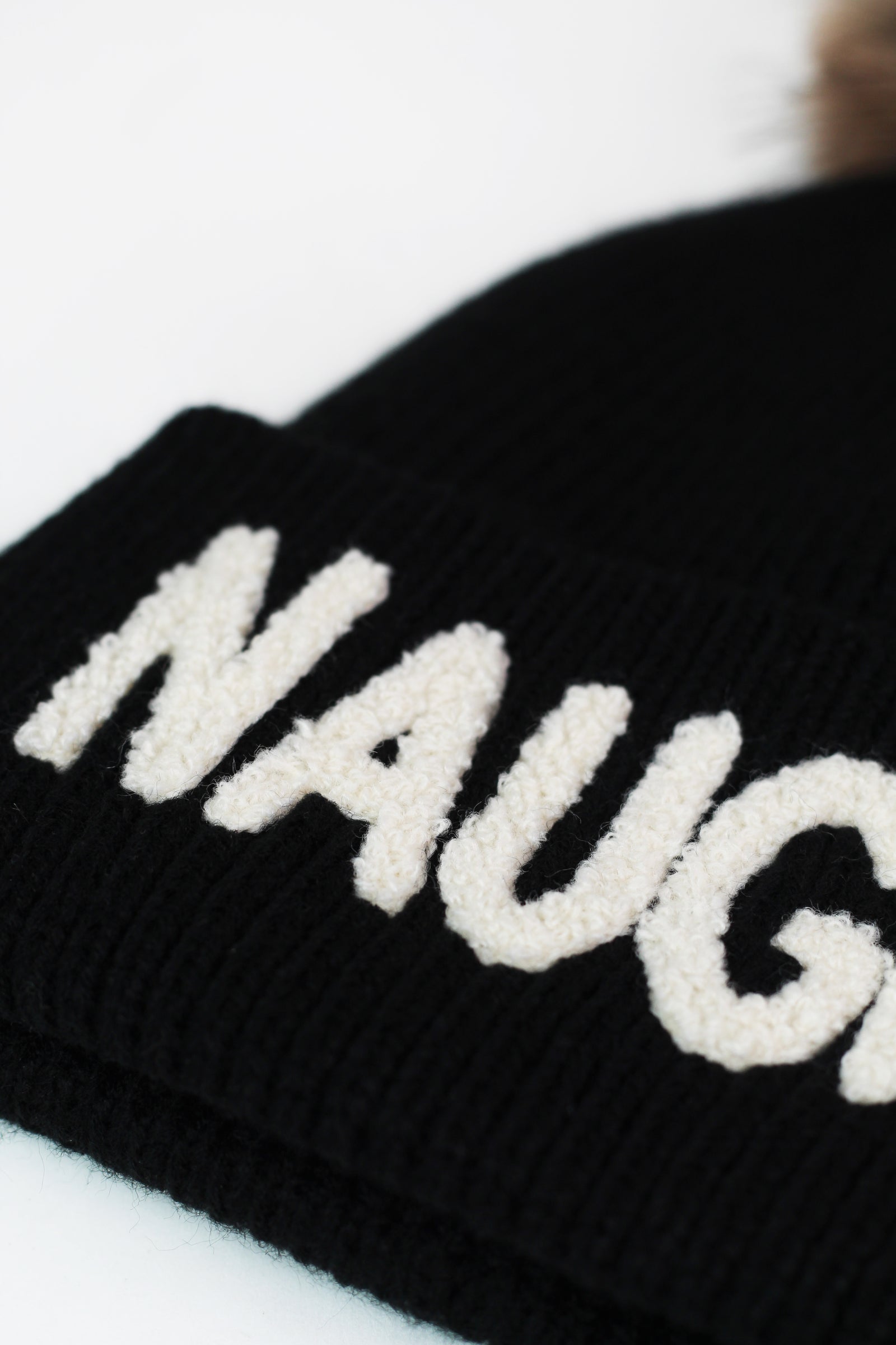 "Naughty" Fleece Lined Hat w/ Faux Fur Pom Pom