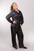 A side view of our model, Stephanie, wearing a shiny black pajama set made with sparkly fabric.