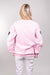 The back view of our model, Lexi, wearing a baby pink sweatshirt covered in Pink, Magenta, Red, Silver and Gold sequin hearts on the front and sleeves. The back is plain.