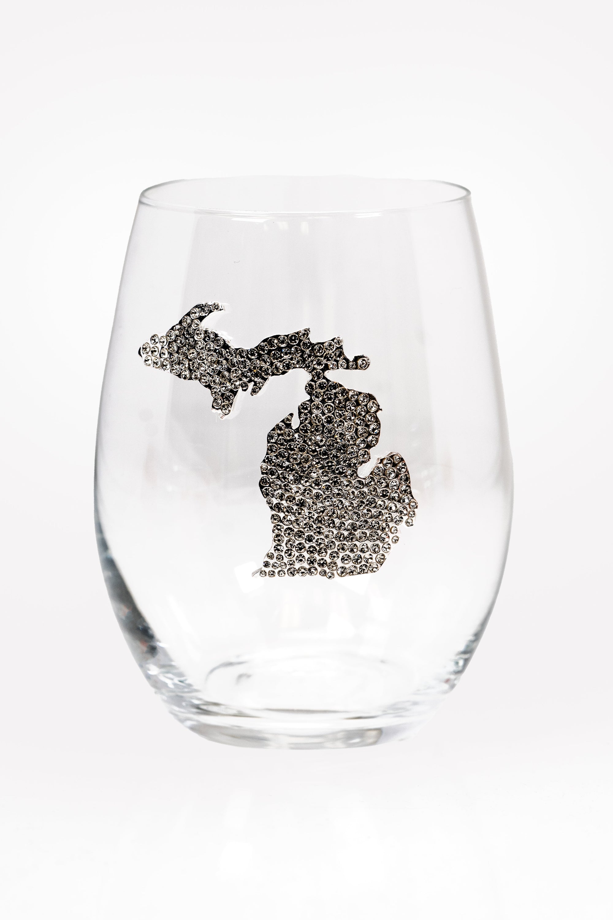 A stemless wine glass with a silver rhinestone silhouette of Michigan on the front.