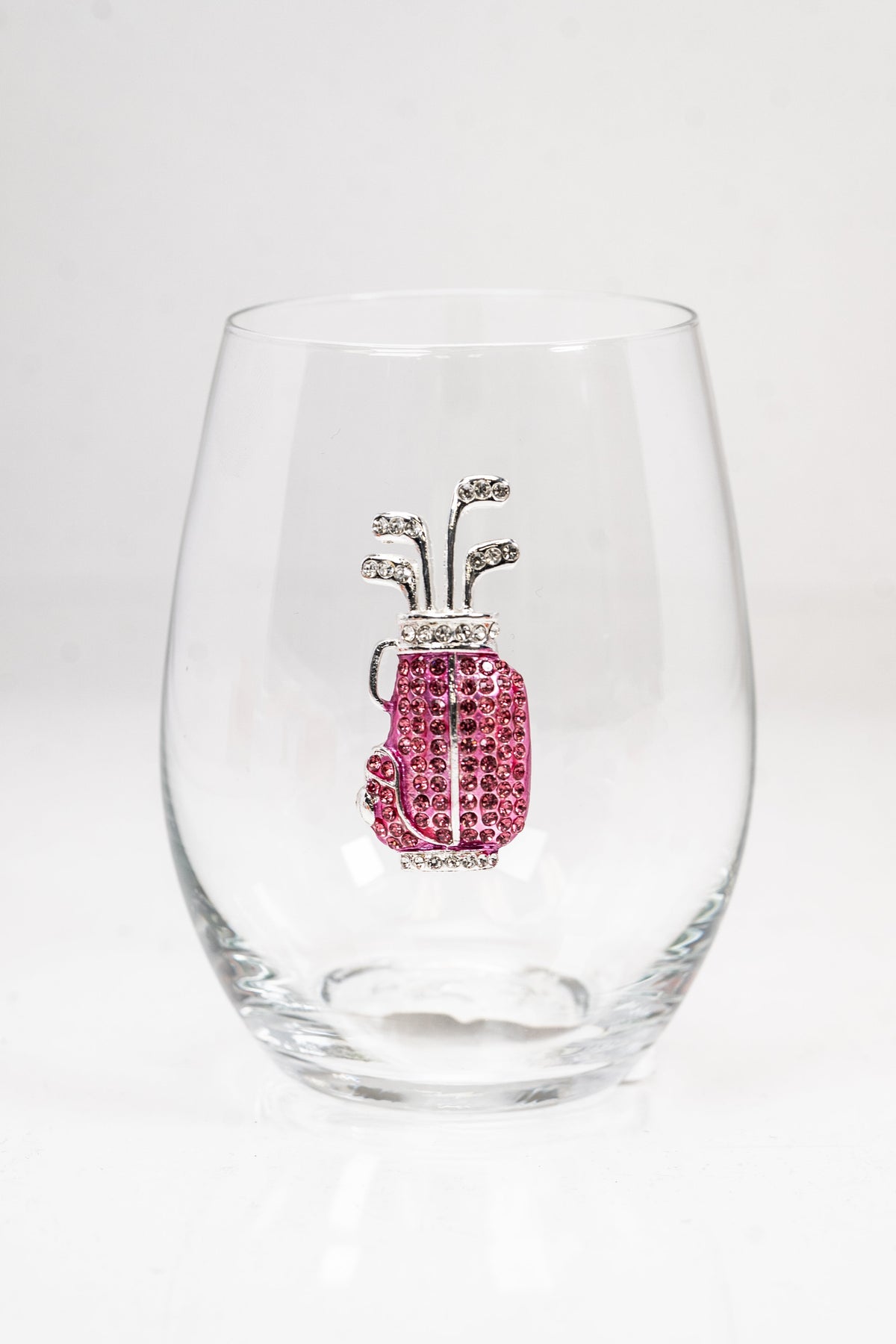 A stemless wine glass with a pink and silver rhinestone golf bag on the front.