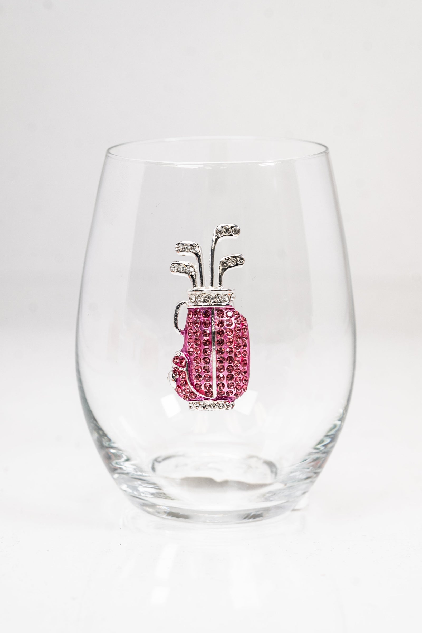 A stemless wine glass with a pink and silver rhinestone golf bag on the front.