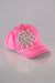 A side view of a bright pink quilted baseball cap with a large rhinestone flower embellished on the front and white stitching detail throughout.