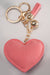 A front view of a pink puffy rhinestone embellished heart keychain with gold hardware.