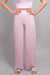 A close-up, front-facing view of our model, Lexi, wearing the crinkled sleeveless cropped top and wide leg pants set in light pink. This set is paired with ivory slide sandals with pearl and rhinestone embellishments. This view is focused on the pants, showing the length of the pant legs, and the detail of the crinkle fabric.