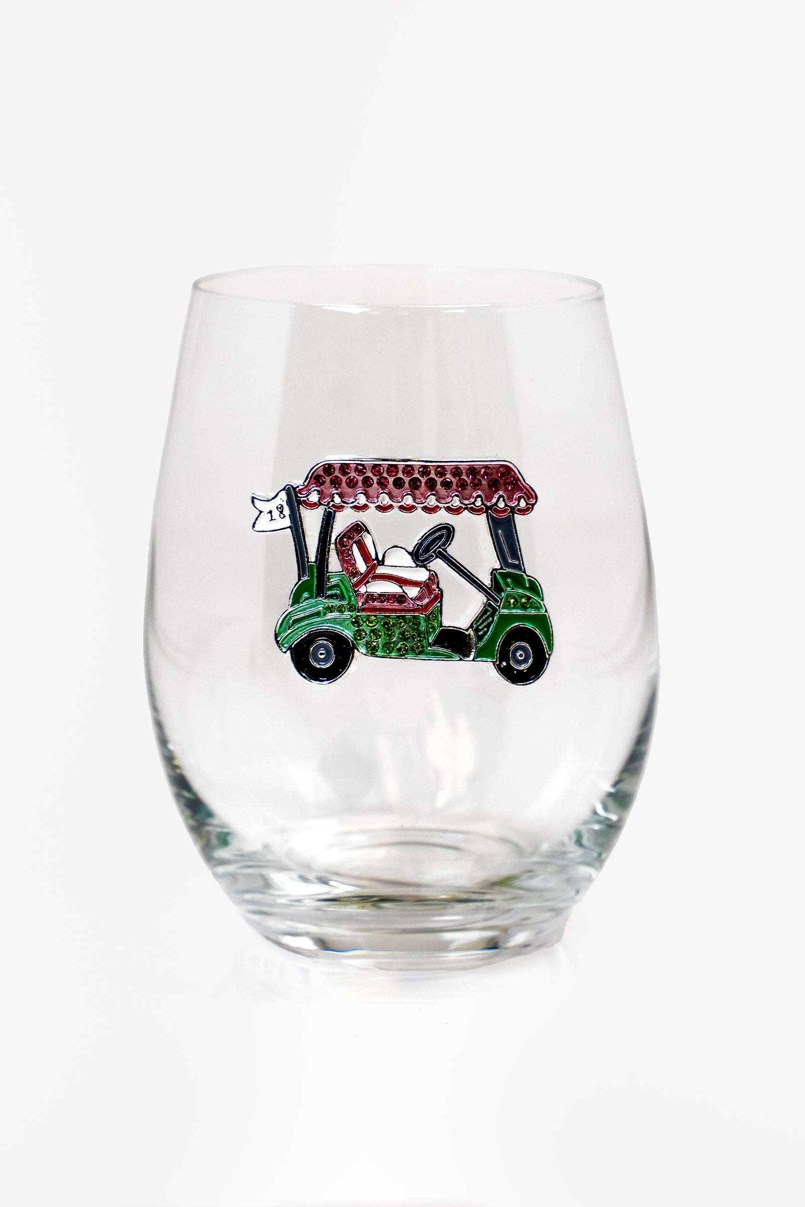 A stemless wine glass with a large rhinestone embellished design on the front of a green, pink and white golf cart.