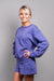 A close-up side view of our model, Lexi, wearing a fleece sweatshirt and shorts set, in Marlin Blue