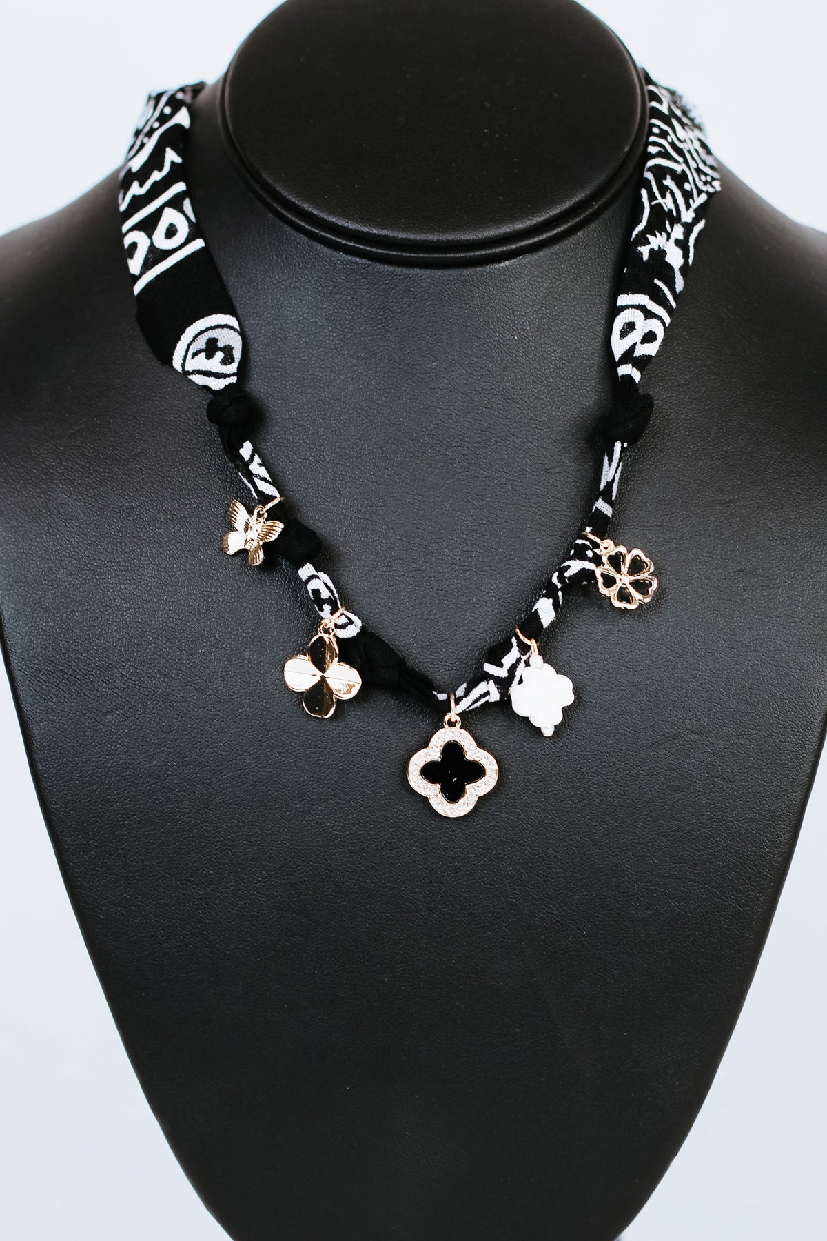 Knotted Fabric w/ Rhinestone Trimmed Clover &amp; Various Charms Necklace