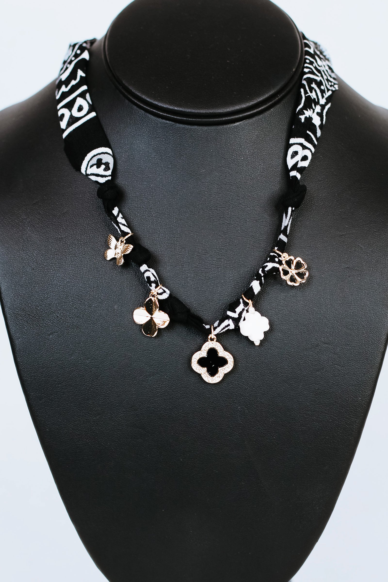 Knotted Fabric w/ Rhinestone Trimmed Clover & Various Charms Necklace