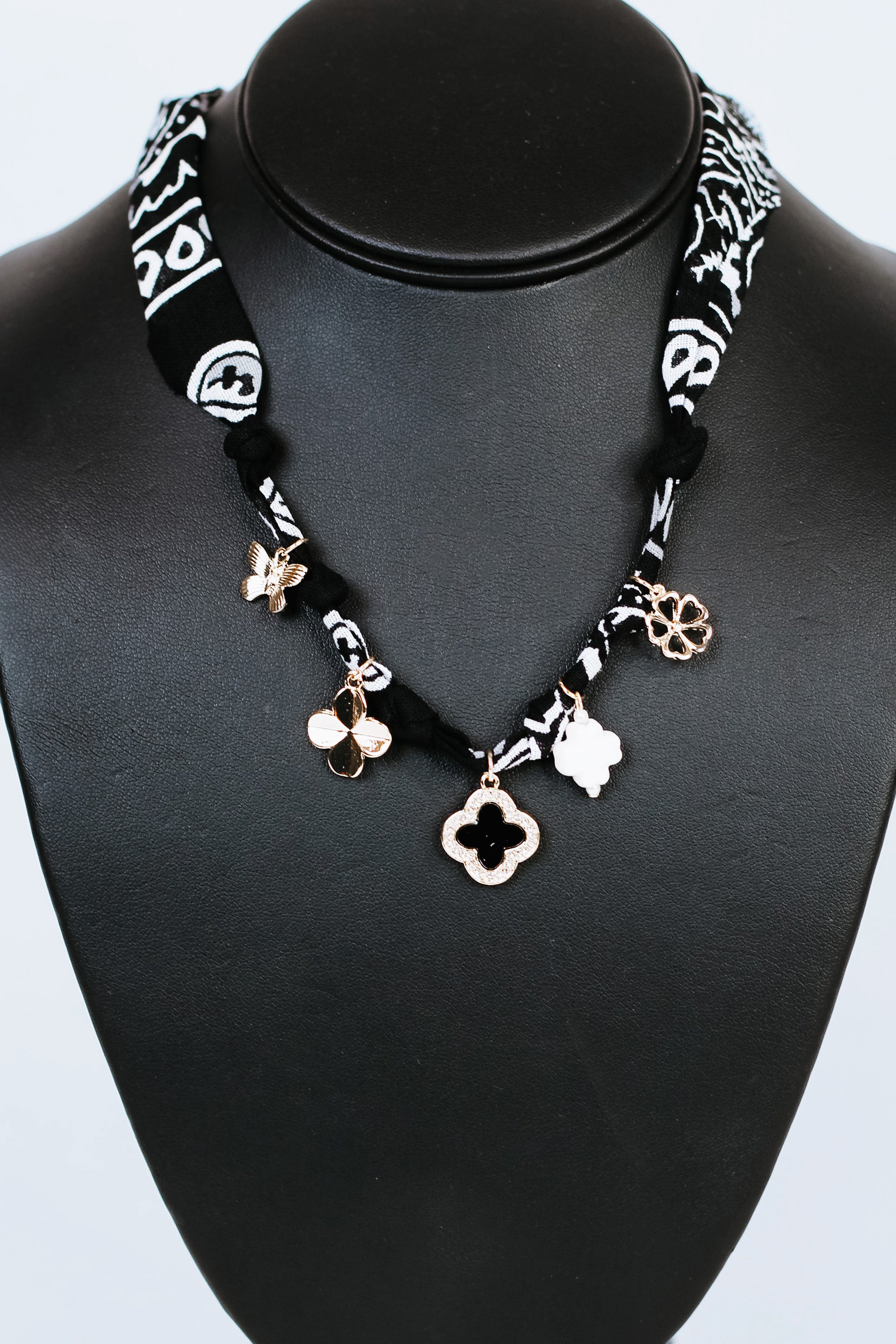 Knotted Fabric w/ Rhinestone Trimmed Clover & Various Charms Necklace