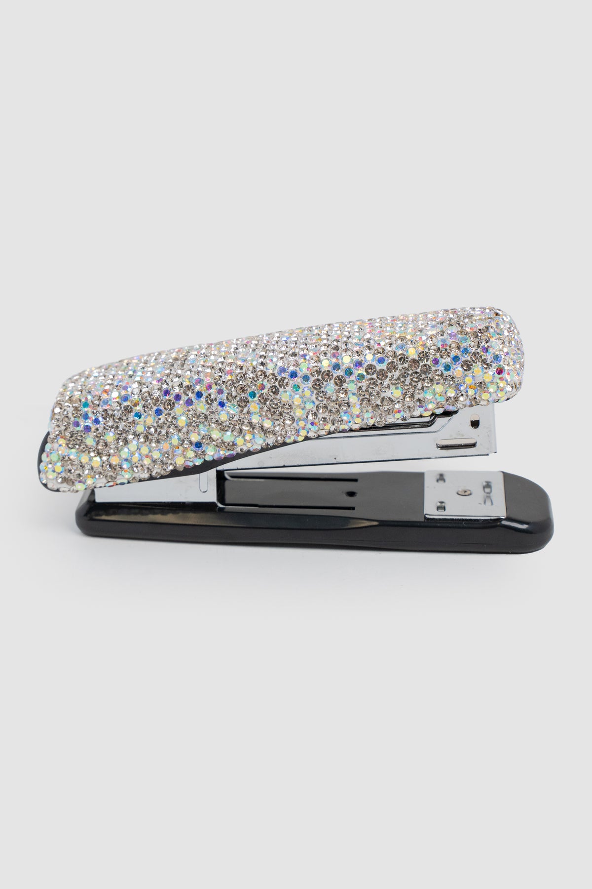 A side view of a black stapler embellished with white and AB rhinestones