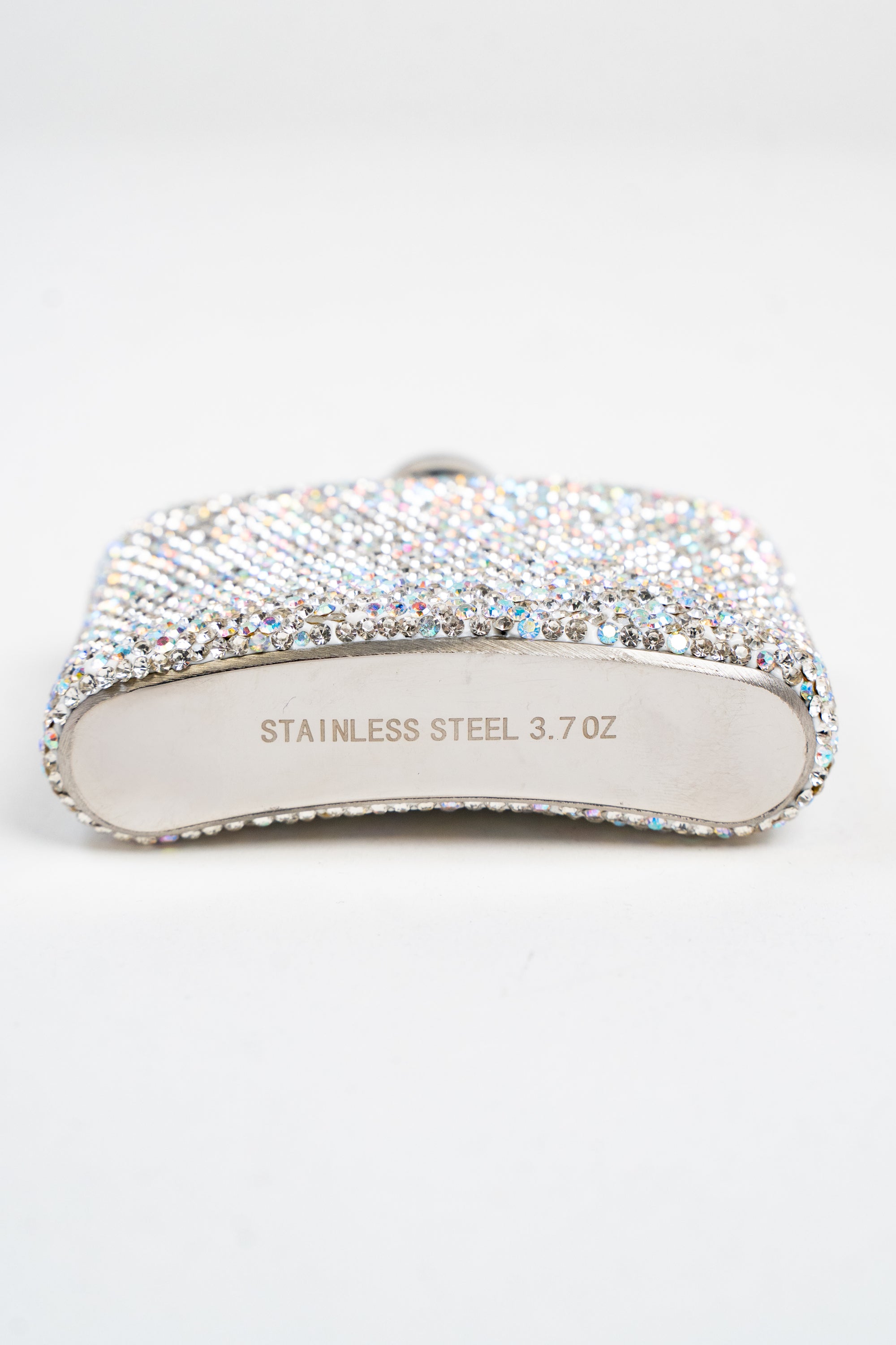 A bottom view of a small flask embellished with silver and AB rhinestones