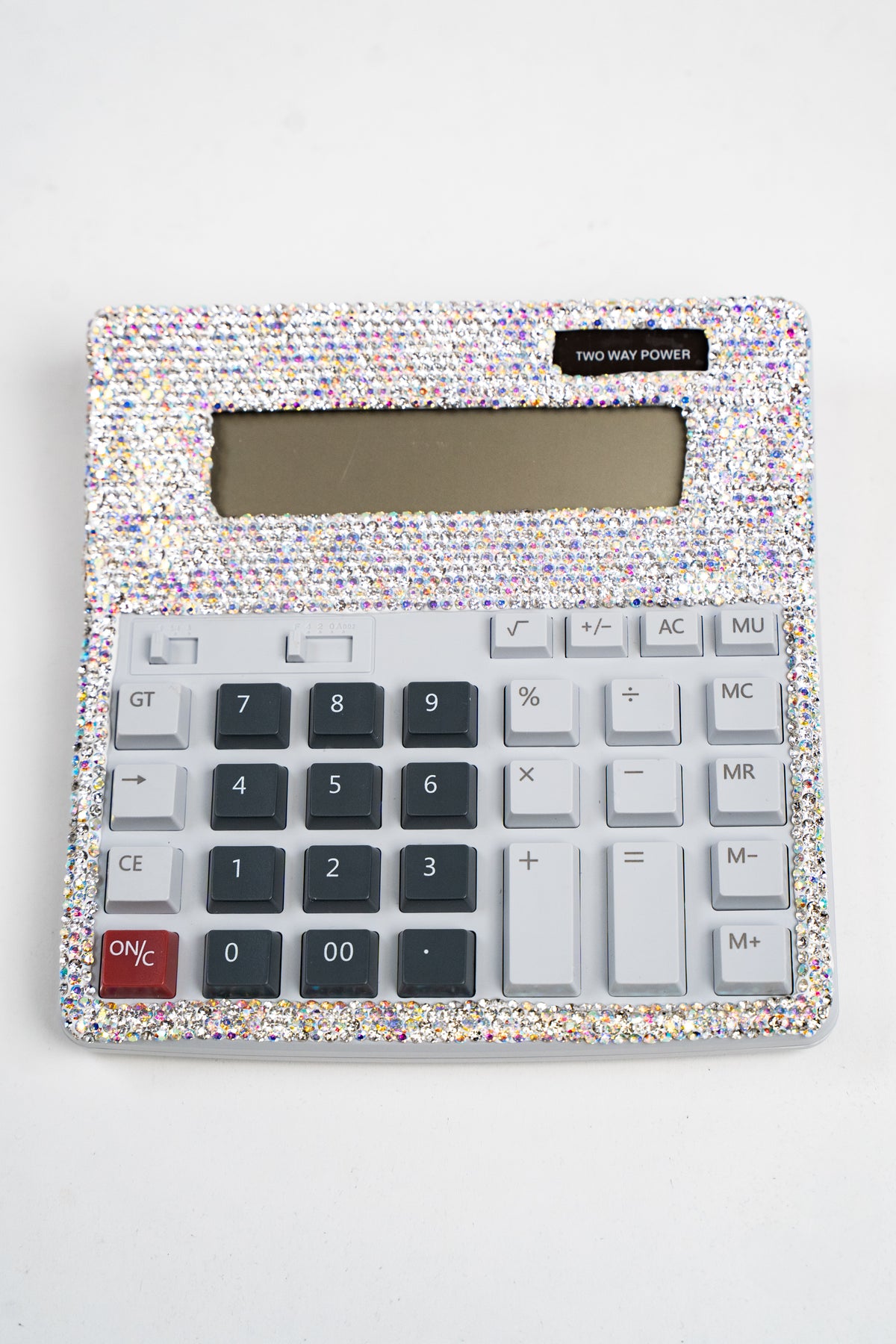 An above view of a large calculator embellished with silver and AB rhinestones