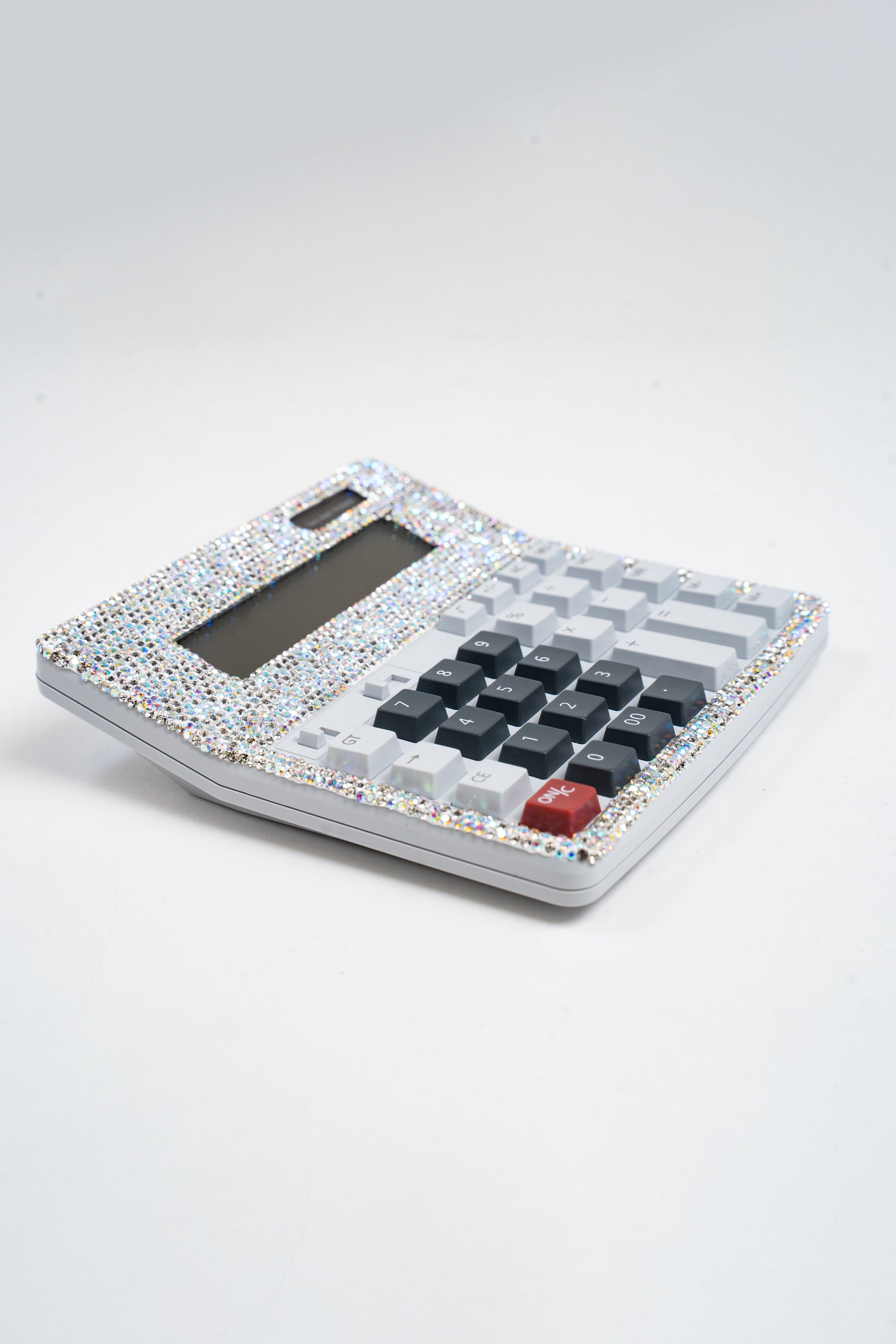 A 3/4 view of a large calculator embellished with silver and AB rhinestones.