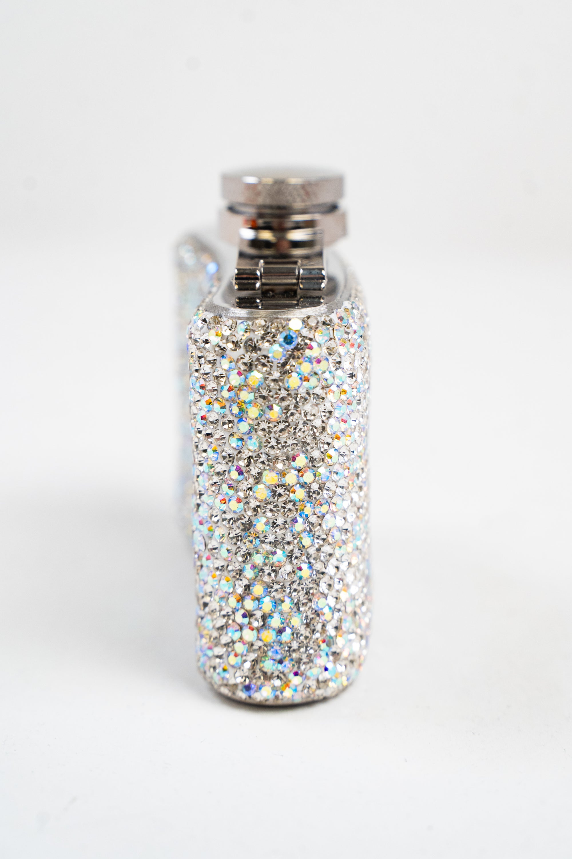 A side view of a small flask embellished with silver and AB rhinestones